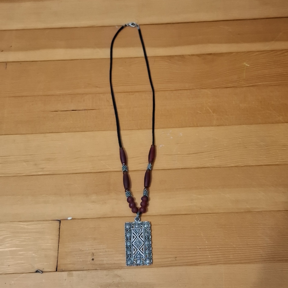 Tribal barber style necklace with rectangular silvertone amulet. Moroccan hirz